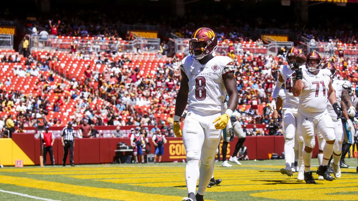 Washington Commanders running back Brian Robinson (8) celebrates his touchdown during the first half of a NFL Preseason football game between the Carolina Panthers and the Washington Commanders on Saturday, Aug. 13, 2022 at FedExField in Landover, Md.
