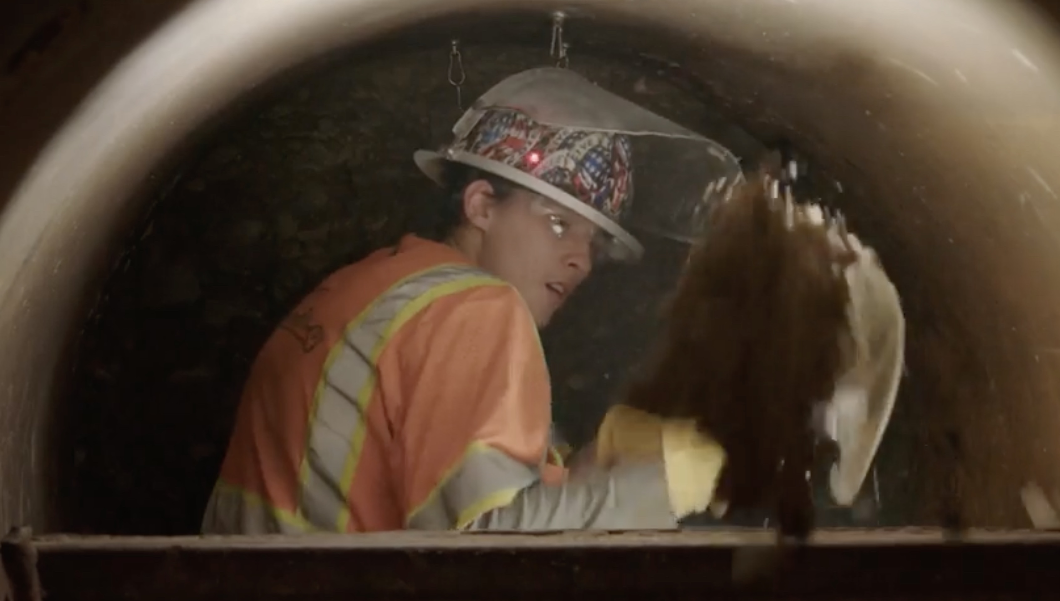 Dakotah Hansen, a tunneling miner for the construction company HDD Willco, shovels out dirt from under the Salt Lake Temple to make way for new jack and bore pipes.