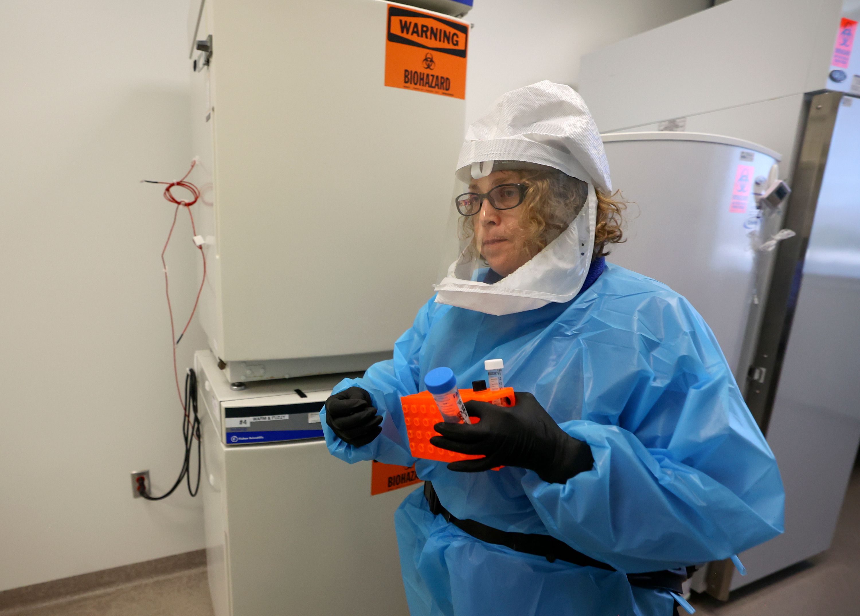 Annette Atkinson, Utah Public Health Laboratory infectious disease microbiologist, carries supplies to process monkeypox test samples in Taylorsville on Thursday. Although monkeypox is primarily affecting men who have sex with men during the current outbreak, public health officials stress the virus can be spread to anyone.