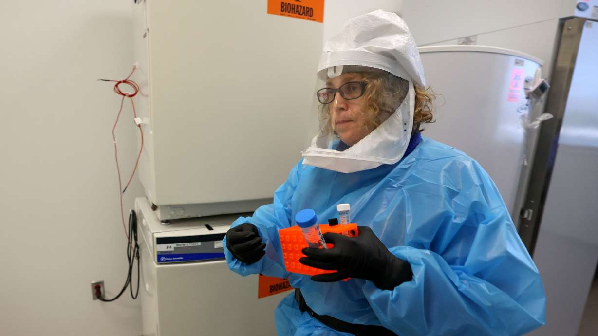Annette Atkinson, Utah Public Health Laboratory infectious disease microbiologist, carries supplies to process monkeypox test samples in Taylorsville on Thursday. Although monkeypox is primarily affecting men who have sex with men during the current outbreak, public health officials stress the virus can be spread to anyone.