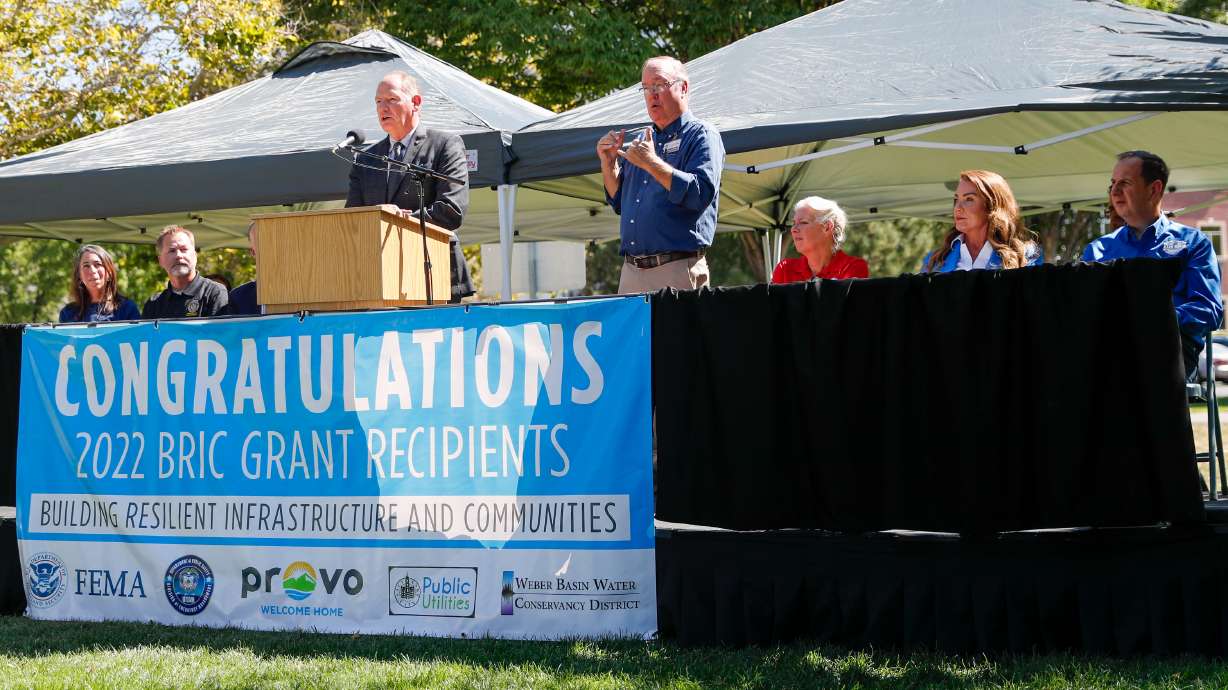 Scott Paxman, general manager of the Weber Basin Water Conservancy District, left, speaks during a press conference in Provo on Monday, where the Federal Emergency Management Agency announced more than $100 million dollars in funding for three Utah resiliency projects.
