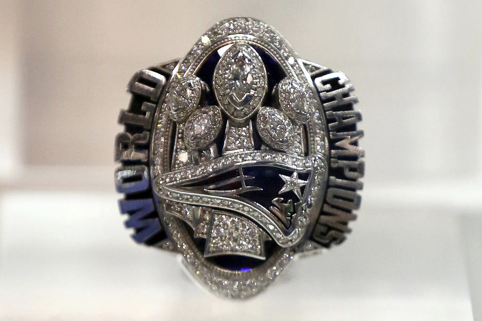 FILE - A New England Patriots Super Bowl LI ring is displayed at the Super Bowl Rings exhibit in Indianapolis, March 1, 2018. A New Jersey man who posed as a former New England Patriots player in order to buy and sell Super Bowl rings that he claimed were gifts to Tom Brady's family has been sentenced to three years in federal prison. 