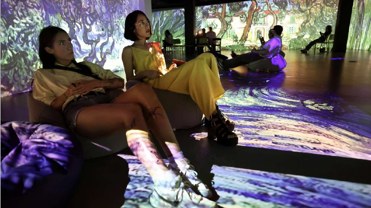 Lindsey Dunlap and Lilian Aguilar watch "From Monet to Kandinsky," an immersive experience offered with Spanish narration, at The Leonardo in Salt Lake City on Tuesday.