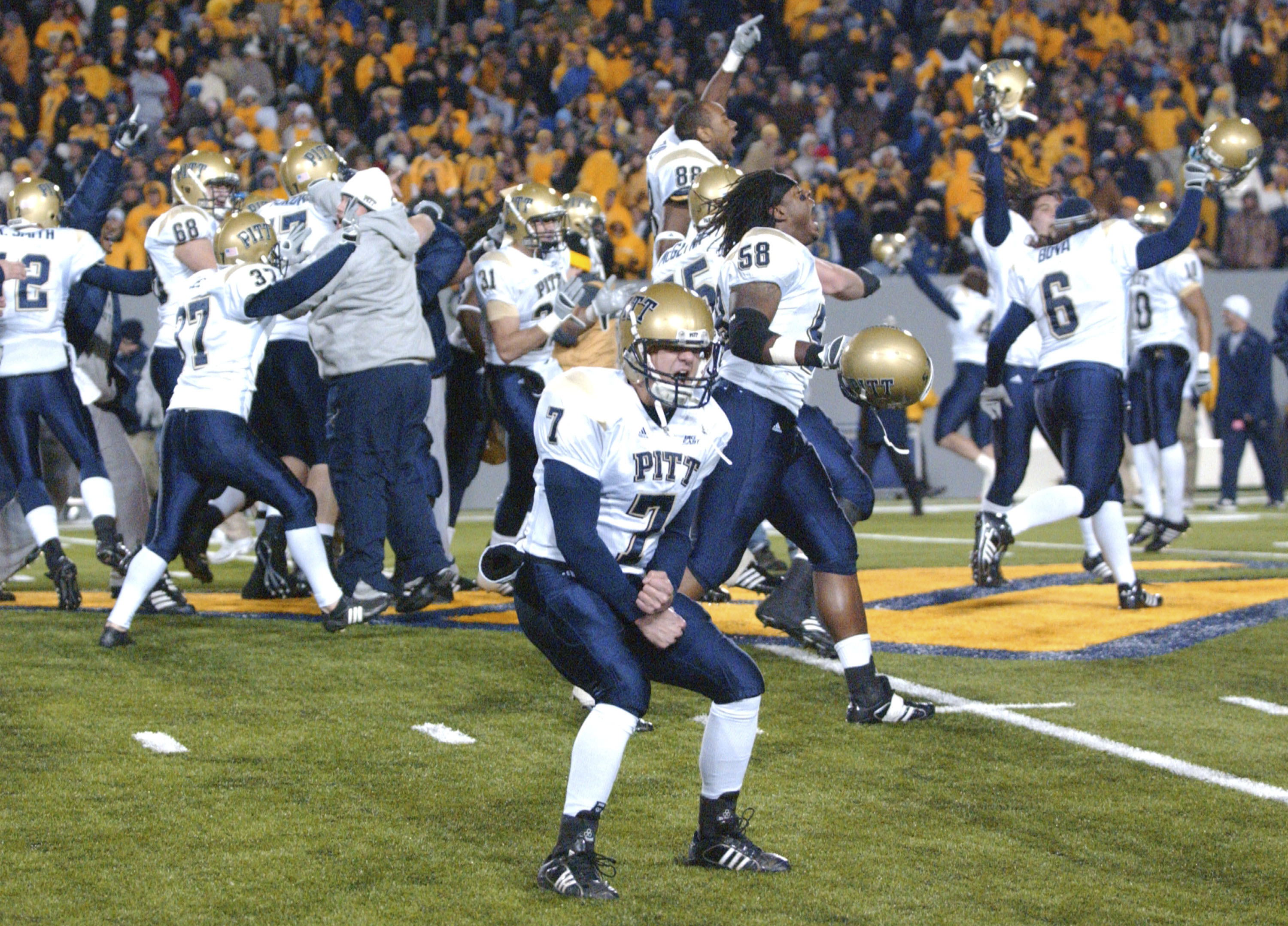 FILE - Pittsburgh's Steve Malinchak (7) and teammates celebrate their 13-9 upset win over No. 2 West Virginia in an NCAA college football game Dec. 1, 2007, in Morgantown, W.Va. The rivalry between the longtime rivals will be renewed following an 11-year hiatus on Thursday, Sept. 1, 2022, when the 17th-ranked Panthers host the Mountaineers. 