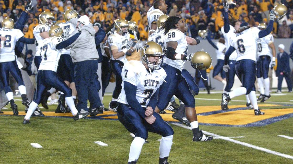FILE - Pittsburgh's Steve Malinchak (7) and teammates celebrate their 13-9 upset win over No. 2 West Virginia in an NCAA college football game Dec. 1, 2007, in Morgantown, W.Va. The rivalry between the longtime rivals will be renewed following an 11-year hiatus on Thursday, Sept. 1, 2022, when the 17th-ranked Panthers host the Mountaineers.