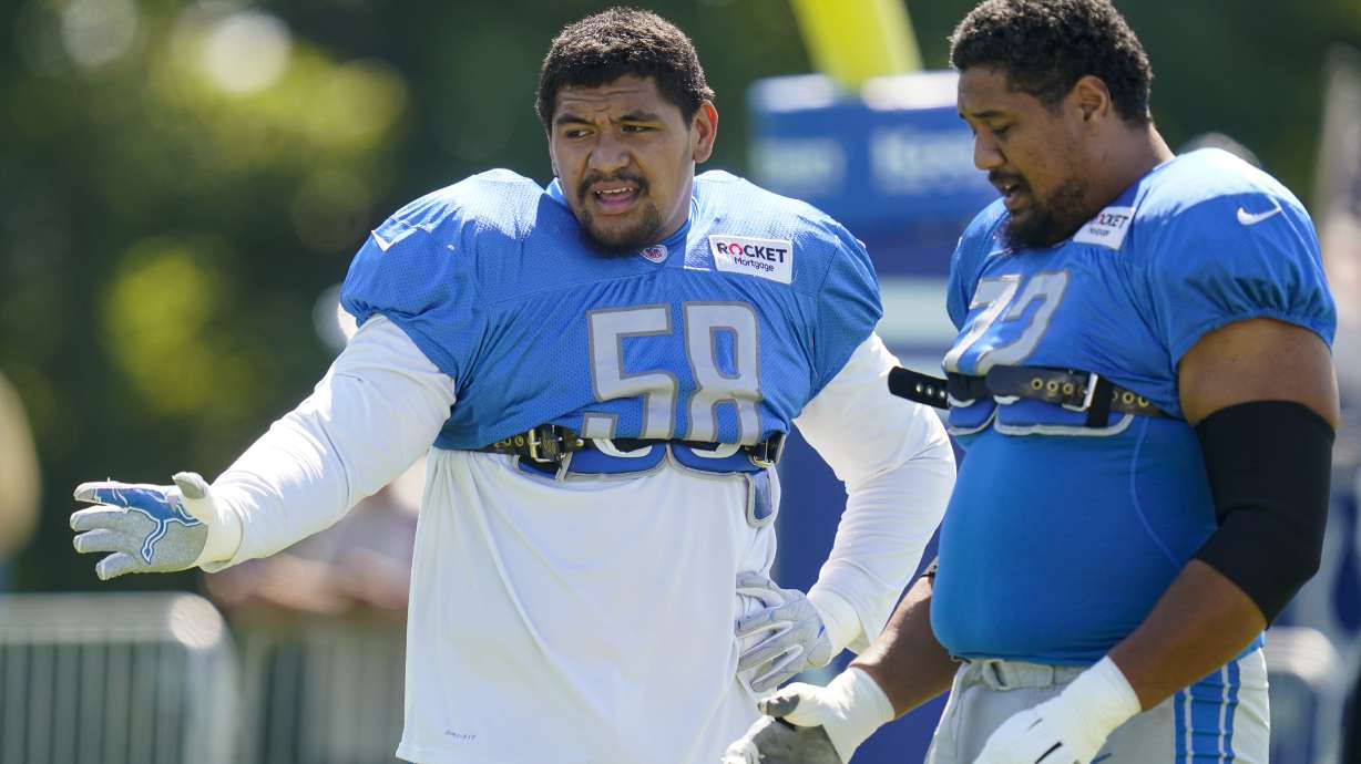 Detroit Lions offensive tackle Penei Sewell (58) talks with guard Halapoulivaati Vaitai (72) during a joint practice with the Indianapolis Colts at NFL football training camp in Westfield, Ind., Thursday, Aug. 18, 2022.