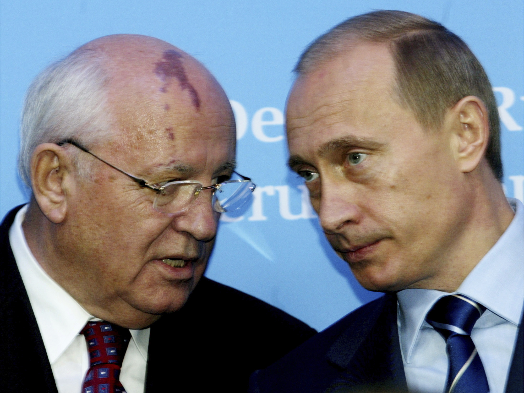 Russia's President Vladimir Putin, right, talks with former Soviet President Mikhail Gorbachev at the start of a news conference at the Castle of Gottorf in Schleswig, northern Germany, Dec. 21, 2004.