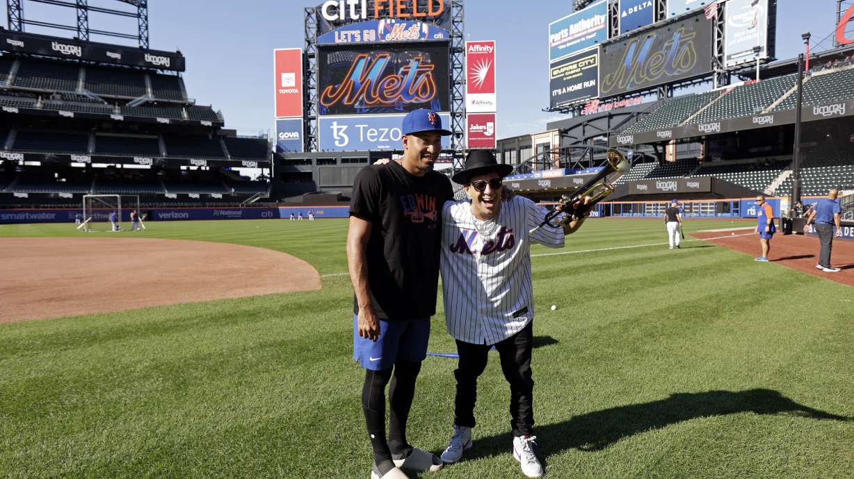 Musician Timmy Trumpet takes a photo with New York Mets' Edwin Diaz, left, before a baseball game against the Los Angeles Dodgers on Tuesday, Aug. 30, 2022, in New York.