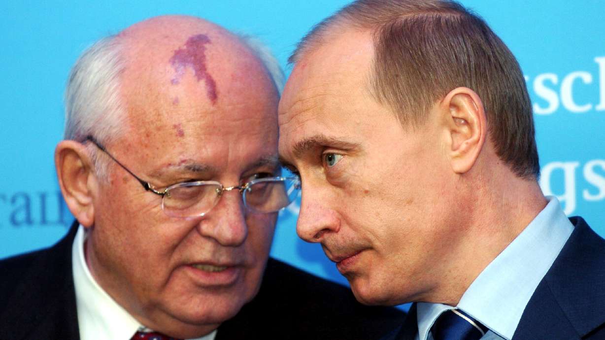 Russia's President Vladimir Putin, right, talks with former Soviet President Mikhail Gorbachev at the start of a news conference at the Castle of Gottorf in Schleswig, northern Germany, Dec. 21, 2004. Russian news agencies are reporting that former Soviet President Mikhail Gorbachev has died at 91.