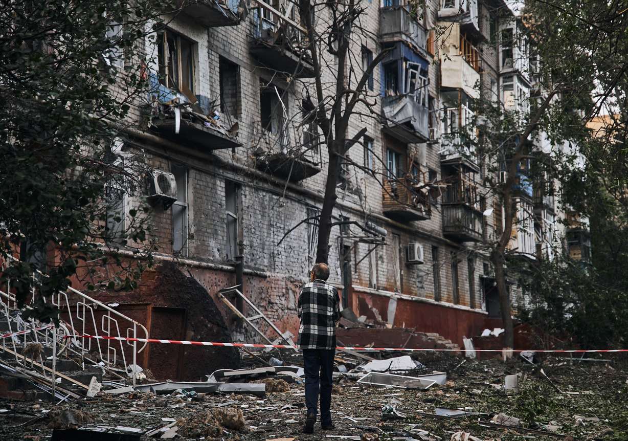A resident looks at a damaged building after a rocket attack early Wednesday morning, in Kramatorsk, eastern Ukraine.