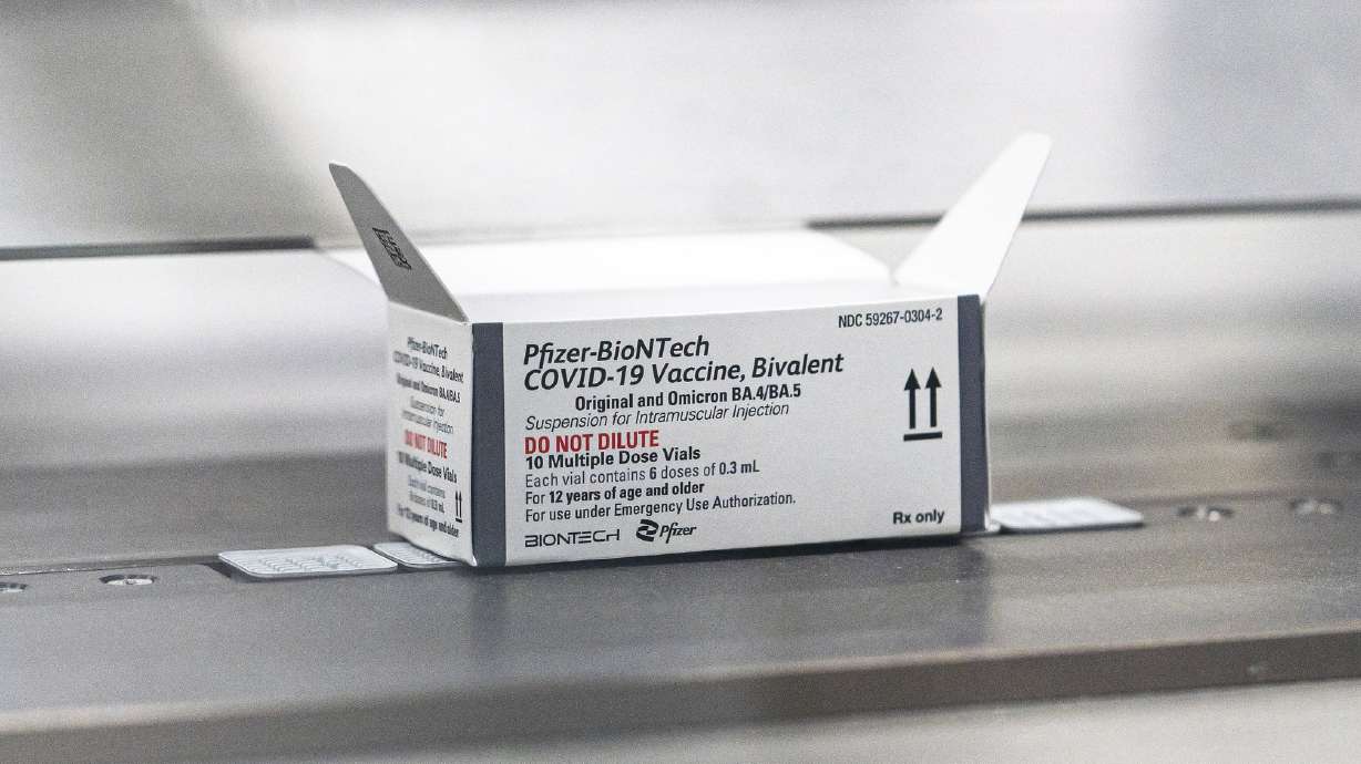 This August 2022 photo provided by Pfizer shows packaging for the company's updated COVID-19 vaccine during production in Kalamazoo, Mich. The new omicron-targeted COVID-19 booster shots may be shipping Friday, but aren't expected to be widely available until after the Labor Day holiday.