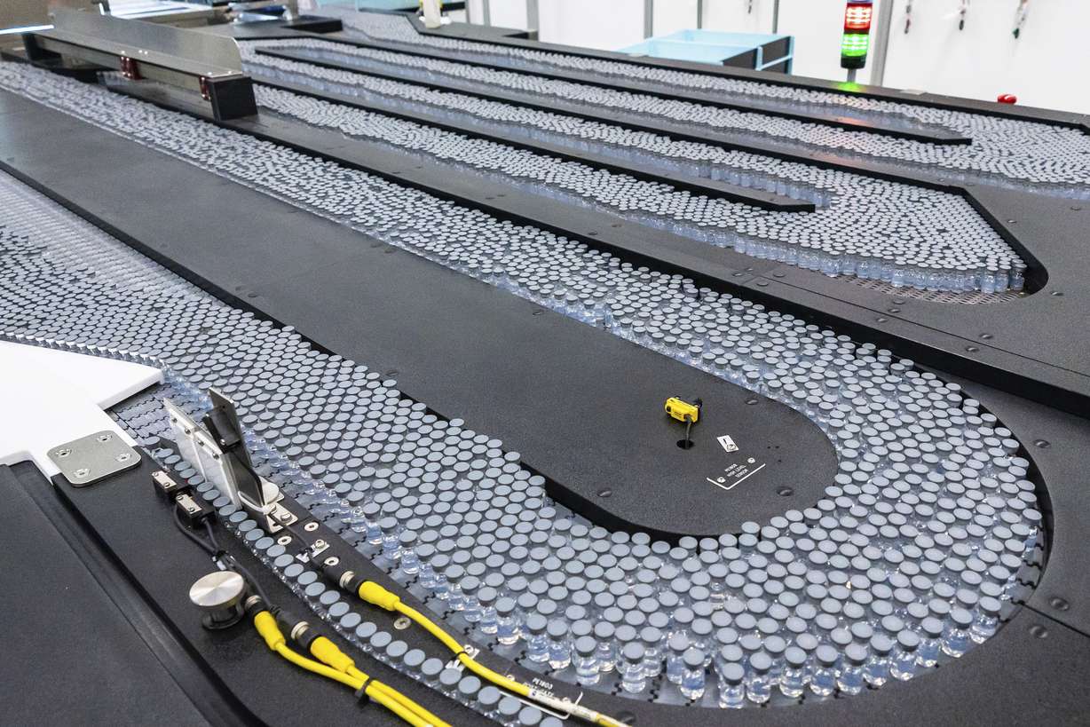 This August 2022 photo provided by Pfizer shows vials of the company's updated COVID-19 vaccine during production in Kalamazoo, Mich.