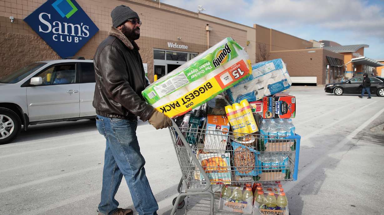 A shopper stocks up on merchandise at a Sam's Club store on January 12, 2018 in Streamwood, Illinois. The warehouse club, owned by Walmart, announced that it's raising its annual membership fee by 11% — from $45 to $50 — beginning in October.