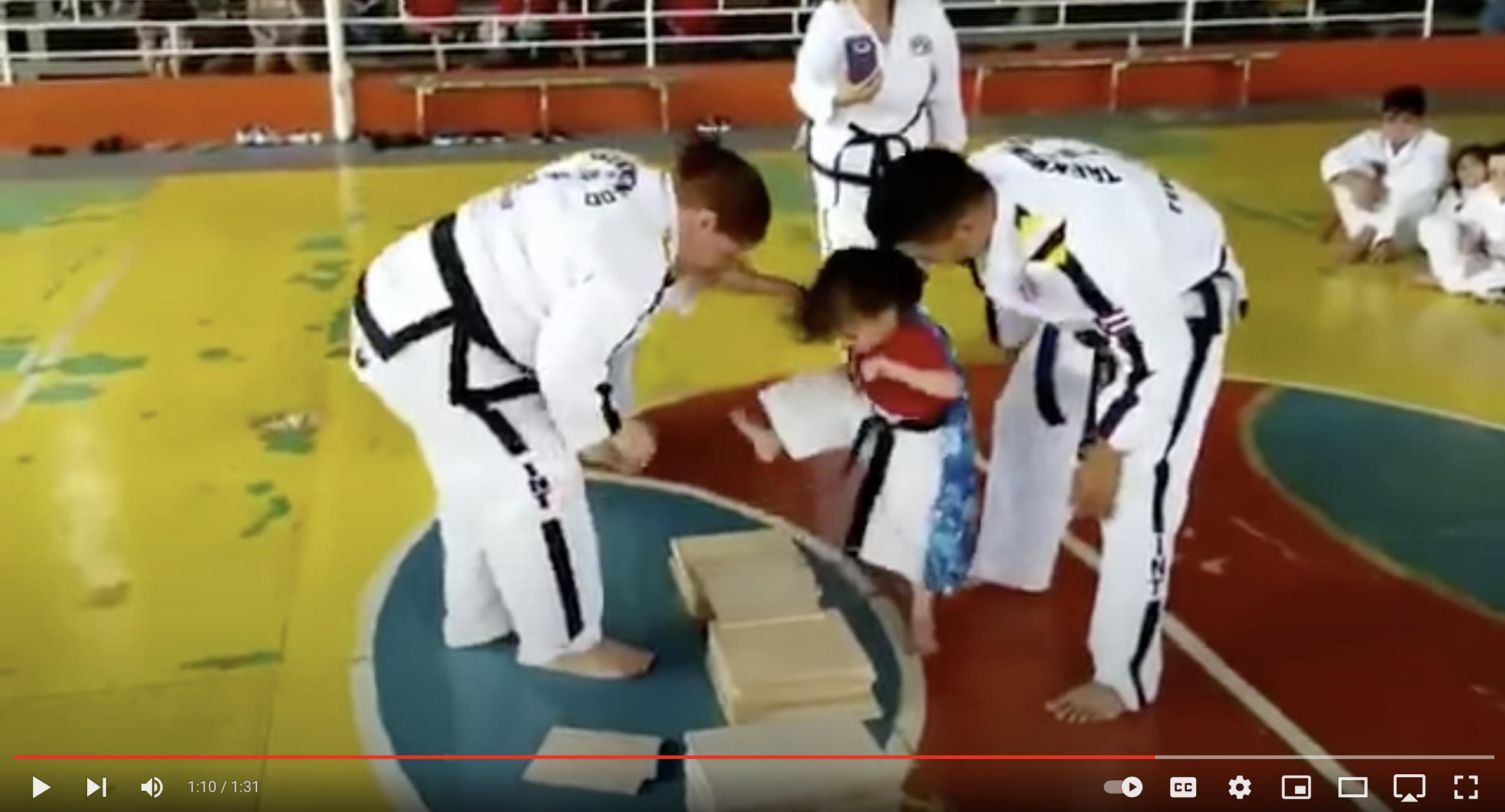 A girl in a tae kwon do class struggles to understand how to break a board in this cute YouTube video. 