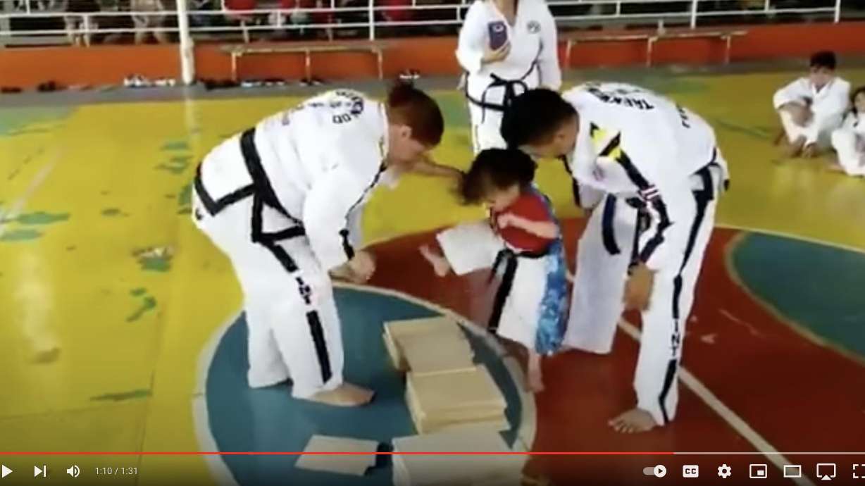 A girl in a tae kwon do class struggles to understand how to break a board in this cute YouTube video.