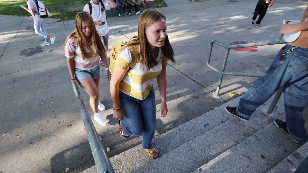 Carol and Audrey Kamerath walk into West High School in Salt Lake City on Tuesday. The school has a little different take on how students should dress for school this year.