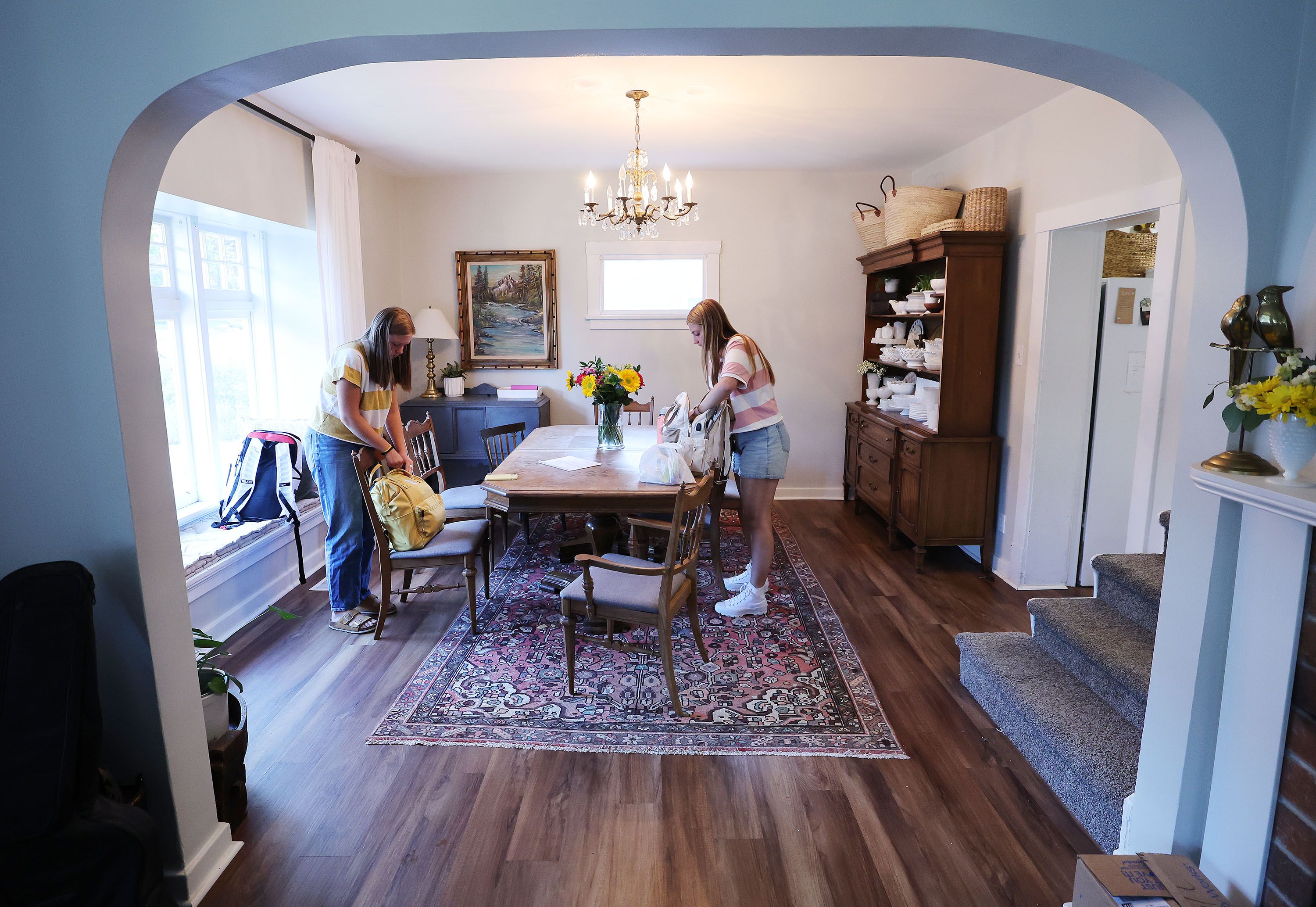 Audrey and Carol Kamerath pack their backpacks at home prior to school at West High in Salt Lake City on Tuesday.