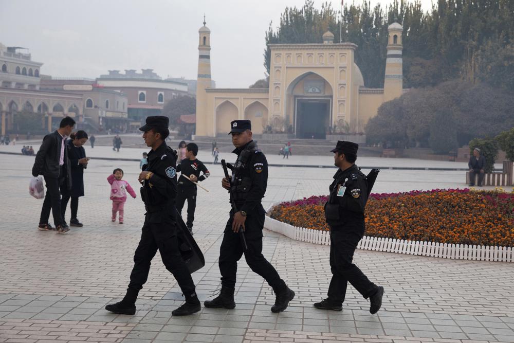 Uyghur security personnel patrol near the Id Kah Mosque in Kashgar in western China's Xinjiang region, Nov. 4, 2017. China's discriminatory detention of Uyghurs and other mostly Muslim ethnic groups in the western region of Xinjiang may constitute crimes against humanity, the U.N. human rights office said in a long-awaited report Wednesday which cited "serious" rights violations and patterns of torture in recent years.