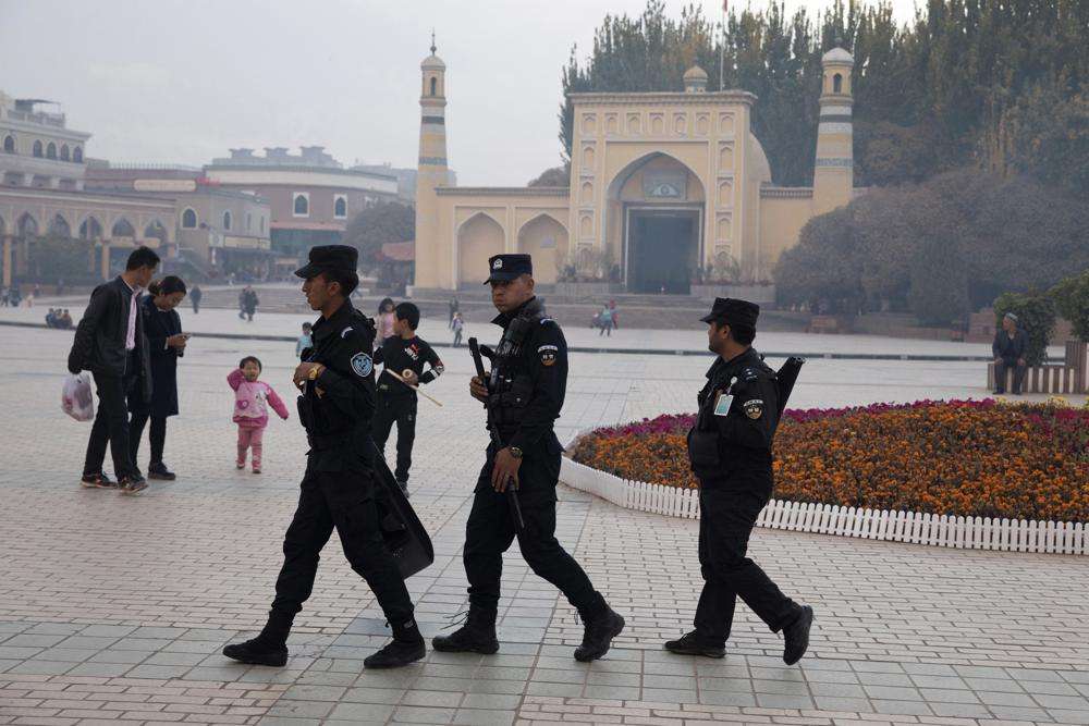 Uyghur security personnel patrol near the Id Kah Mosque in Kashgar in western China's Xinjiang region, Nov. 4, 2017. China's discriminatory detention of Uyghurs and other mostly Muslim ethnic groups in the western region of Xinjiang may constitute crimes against humanity, the U.N. human rights office said in a long-awaited report Wednesday which cited "serious" rights violations and patterns of torture in recent years.
