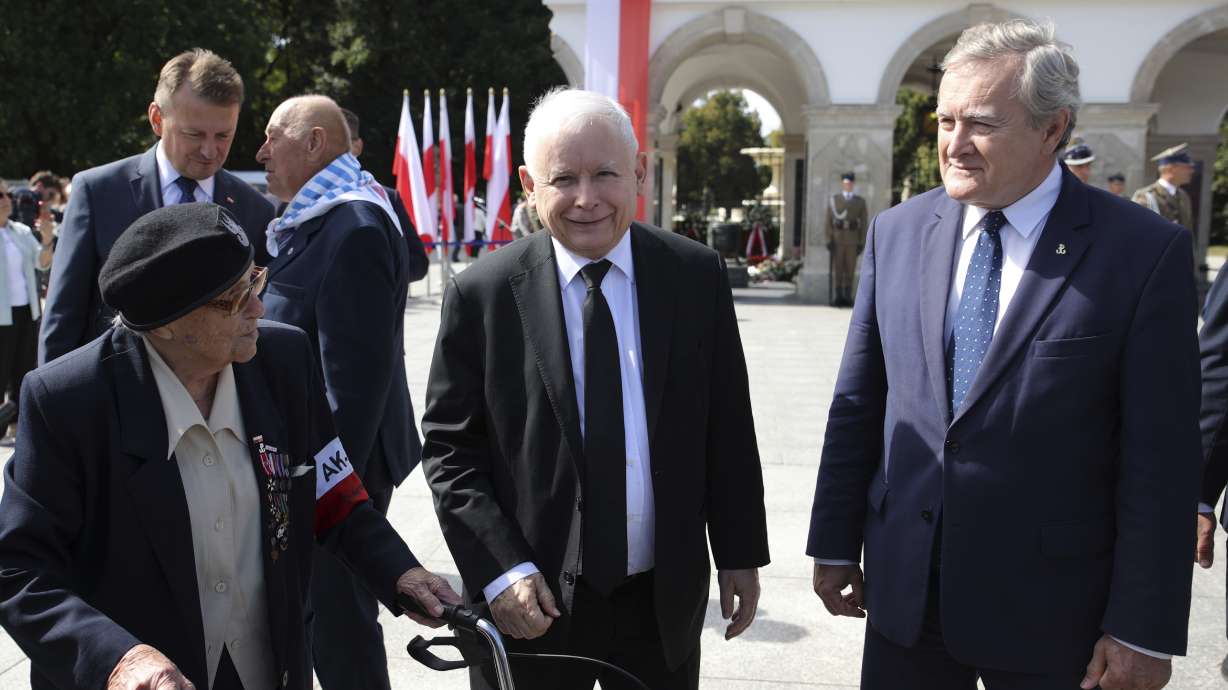Poland's main ruling party leader Jaroslaw Kaczynski, center, attends a wreath laying ceremony marking national observances of the anniversary of World War II in Warsaw, Poland, Thursday. World War II began on Sept. 1, 1939, with Nazi Germany's bombing and invading Poland, for more than five years of brutal occupation.