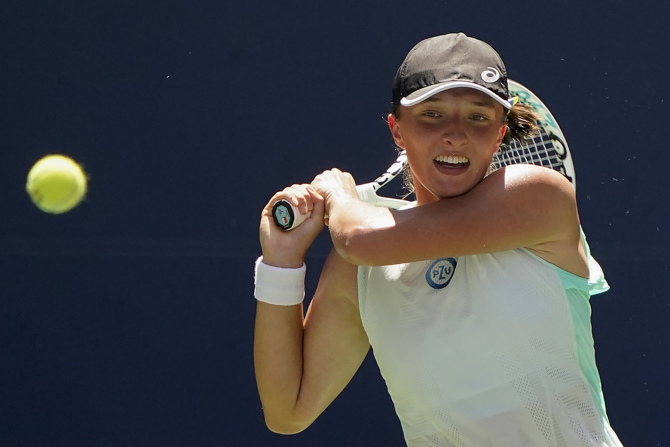 Iga Swiatek, of Poland, returns a shot to Jasmine Paolini, of Italy, during the first round of the US Open tennis championships, Tuesday, Aug. 30, 2022, in New York.