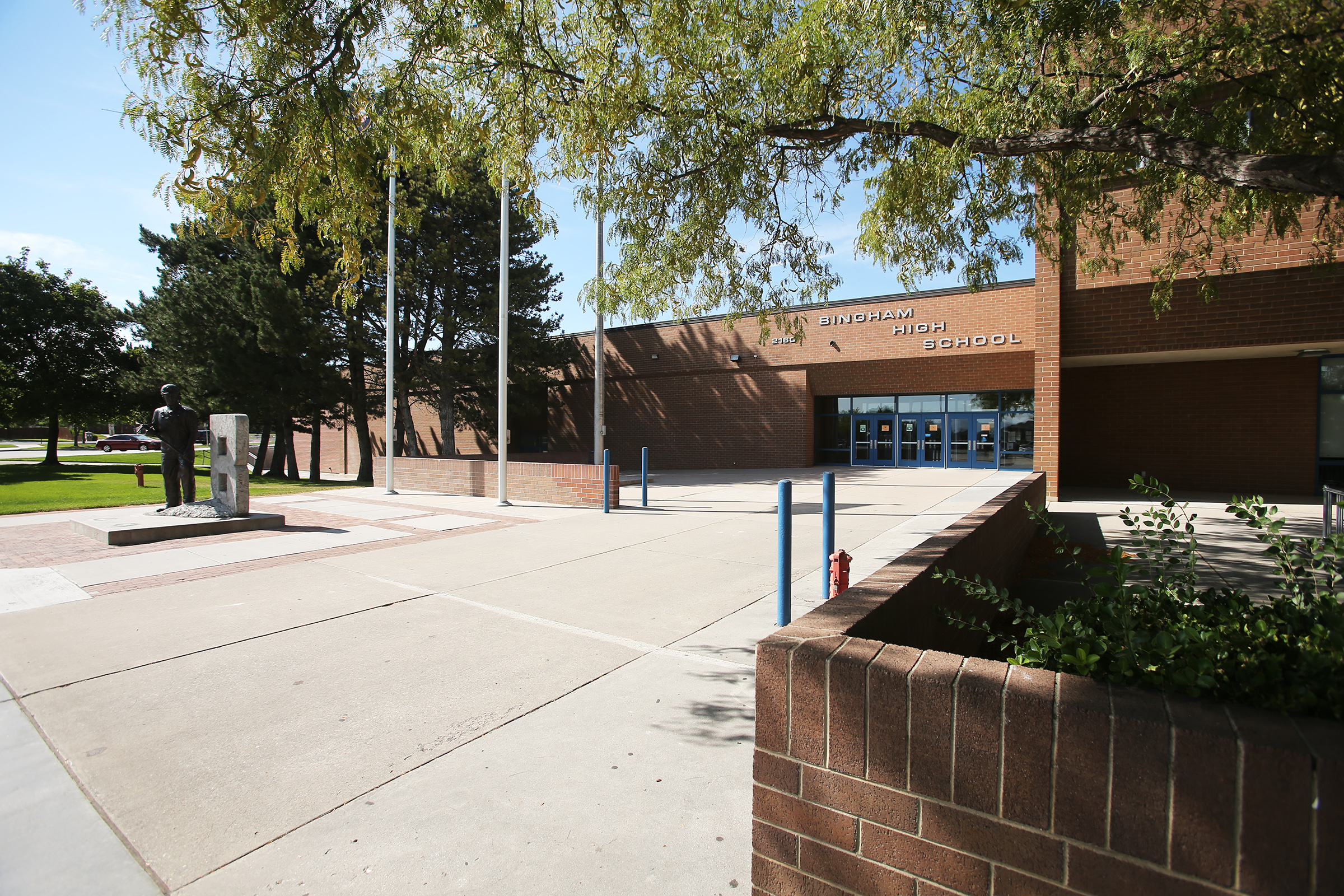 A former assistant wrestling coach at Bingham High School was charged Thursday with having an inappropriate relationship with a student.