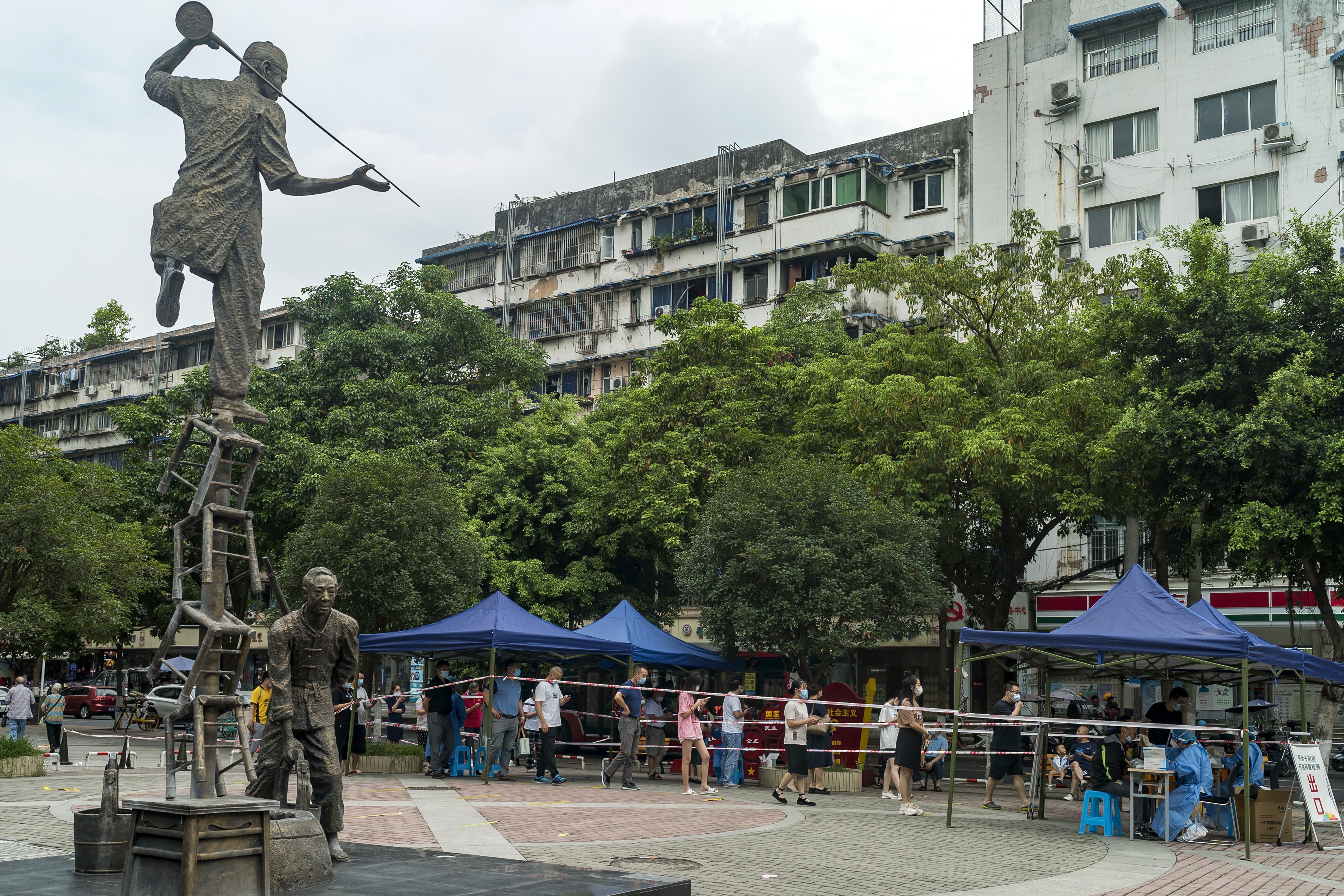 Residents line up for COVID-19 screening in Chengdu in southwestern China’s Sichuan province on Tuesday. Chinese authorities have locked down Chengdu, a southwestern city of 21 million people, following a spike in COVID-19 cases.