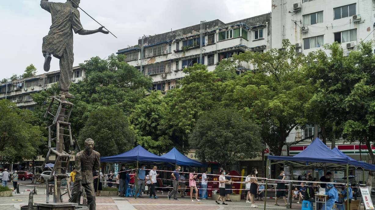 Residents line up for COVID-19 screening in Chengdu in southwestern China’s Sichuan province on Tuesday. Chinese authorities have locked down Chengdu, a southwestern city of 21 million people, following a spike in COVID-19 cases.