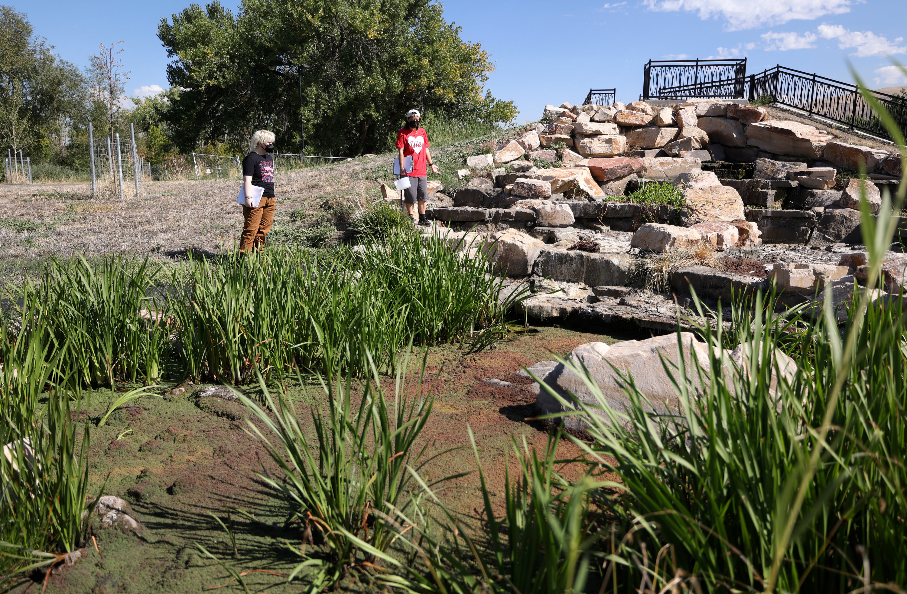 Horizonte student Oakland Voright and her teacher Nat Shiozawa discuss their observations around the Cascades area of the Rose Park Jordan River Watershed Project Cornell Wetland Area in Salt Lake City on Thursday. The feature helps dissolve oxygen into the water and also has a hydrodynamic separator that mechanically removes debris and sediment out of the water.