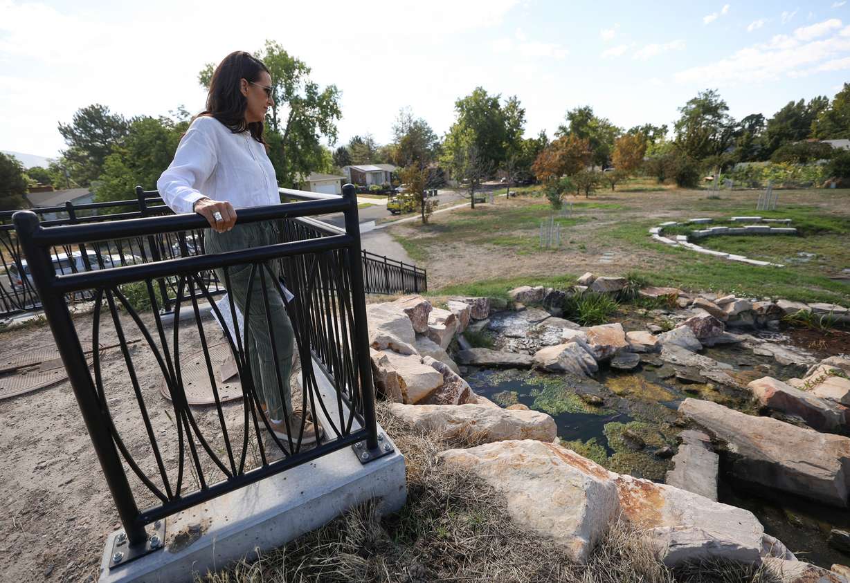 Holly Sweeten, director of outreach for Rep. Burgess Owens, R-Utah, looks out over The Cascades area of the Rose Park Jordan River Watershed Project Cornell Wetland Area in Salt Lake City on Thursday. The feature helps dissolve oxygen into the water and also has a hydrodynamic separator that mechanically removes debris and sediment from the water.
