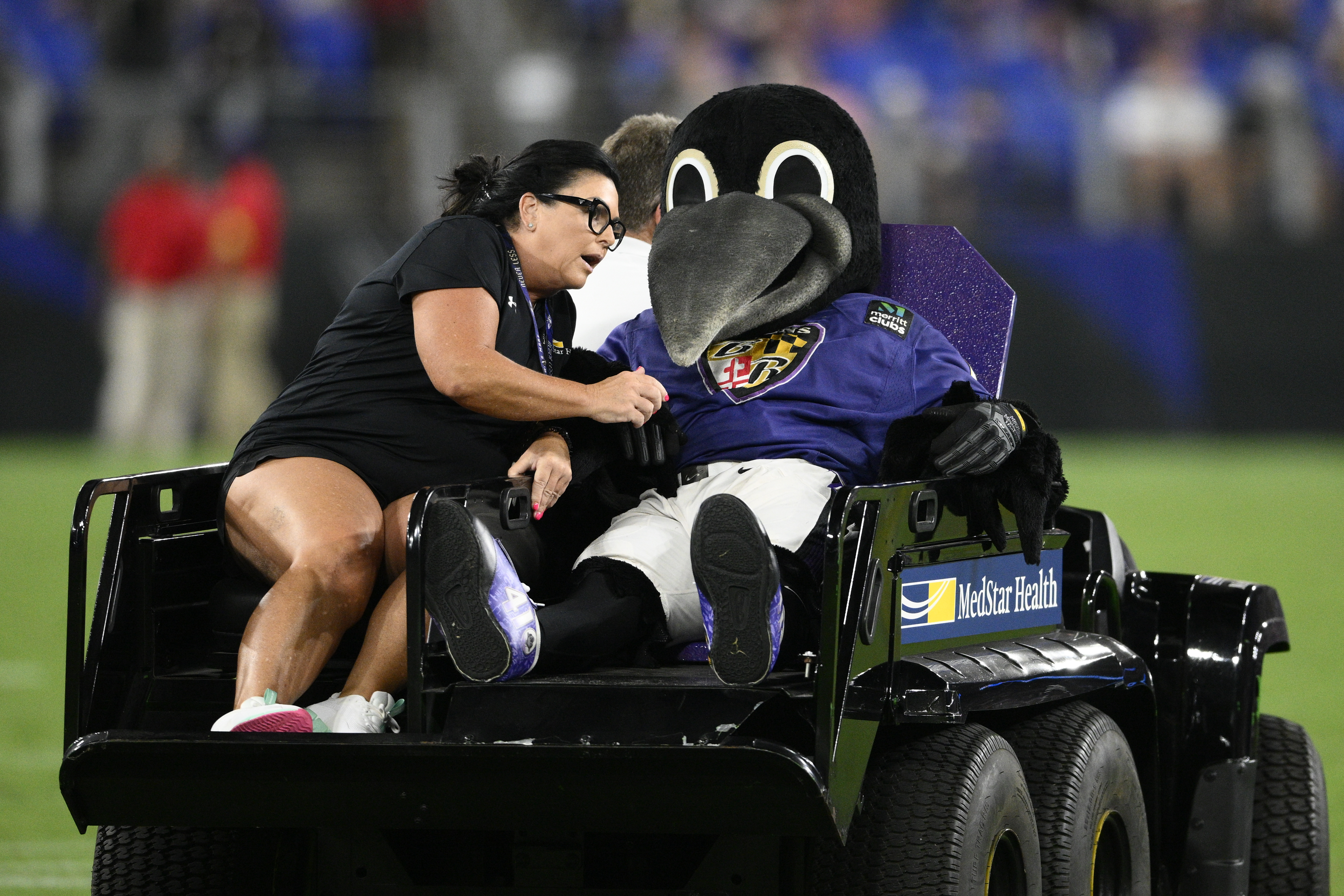 Poe, the Baltimore Ravens' mascot, sits on a medical cart during halftime of a preseason NFL football game between the Ravens and the Washington Commanders, Saturday, Aug. 27, 2022, in Baltimore. 