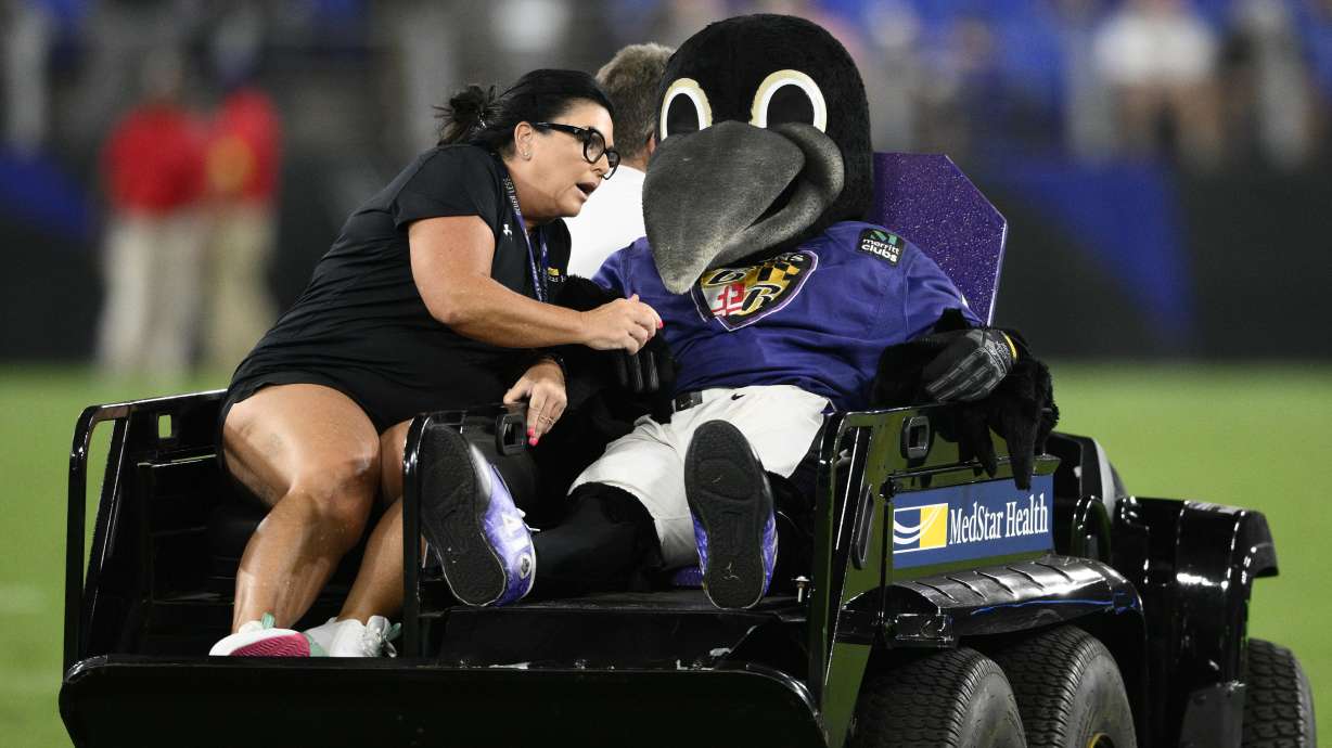 Poe, the Baltimore Ravens' mascot, sits on a medical cart during halftime of a preseason NFL football game between the Ravens and the Washington Commanders, Saturday, Aug. 27, 2022, in Baltimore.