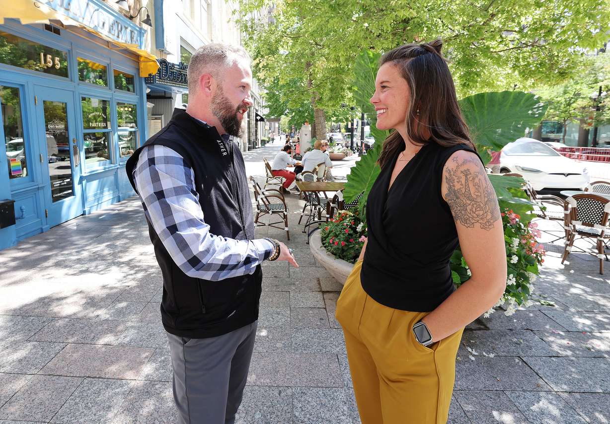 Martin Norman, owner Uniquely Utah Souvenir, chats with Salt Lake City Mayor Erin Mendenhall prior to a press conference in Salt Lake City on Thursday about the 2022 Open Streets initiative and future plans for downtown activation.
