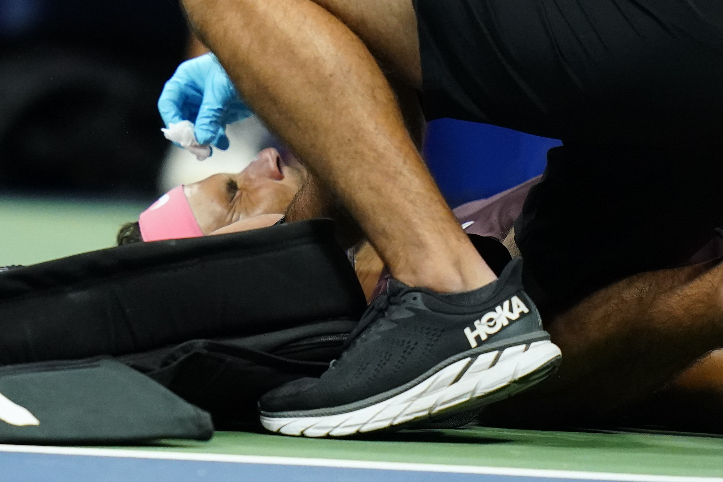 Rafael Nadal, of Spain, is treated by a trainer during a medical timeout during a match against Fabio Fognini, of Italy, during the second round of the U.S. Open tennis championships, early Friday, Sept. 2, 2022, in New York. Nadal's racket head rebounded off the court and hit his nose. 