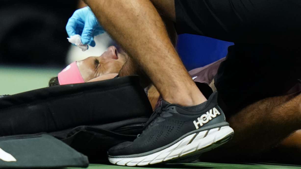 Rafael Nadal, of Spain, is treated by a trainer during a medical timeout during a match against Fabio Fognini, of Italy, during the second round of the U.S. Open tennis championships, early Friday, Sept. 2, 2022, in New York. Nadal's racket head rebounded off the court and hit his nose.