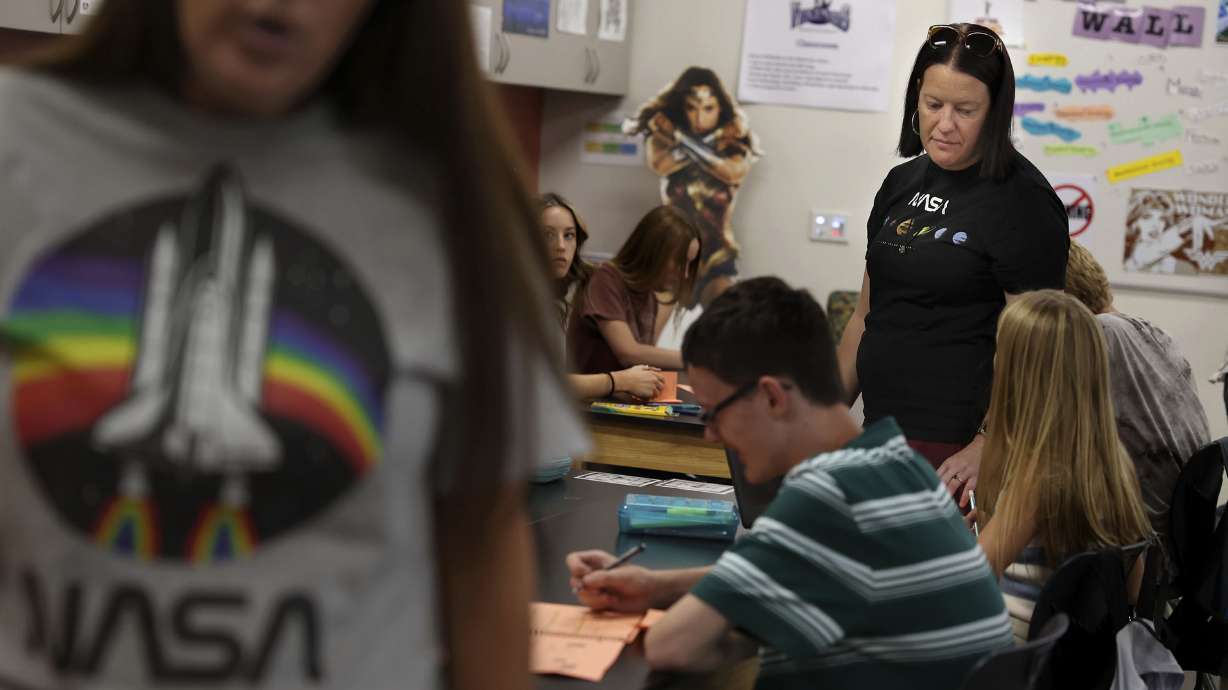 Instructional aid Rebecca Watson, left, and science teacher Jennifer Muir, right, work with eighth graders at Draper Park Middle School on Friday. Muir, who was chosen to attend a prestigious NASA-affiliated teacher training program that includes a flight to the stratosphere, leaves Monday, Sept. 12, for the five-day trip.