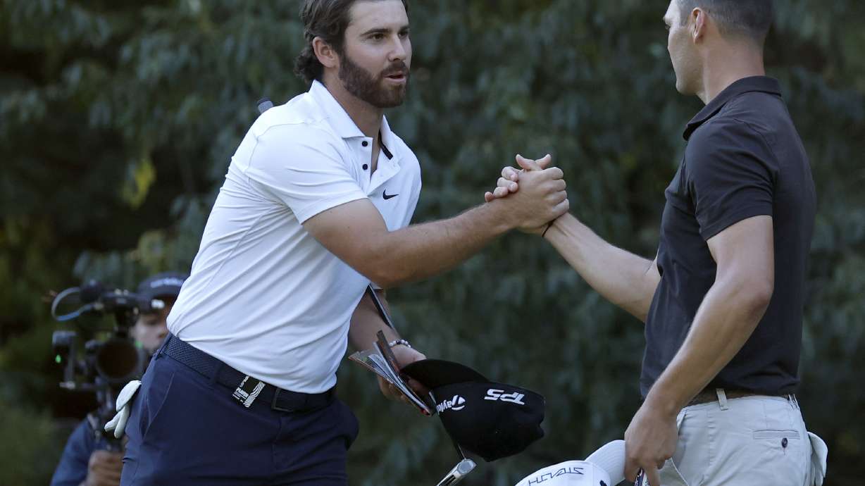 Matthew Wolff, left, shakes hands with Martin Kaymer after they finished the first round of the LIV Golf Invitational-Boston tournament, Friday, Sept. 2, 2022, in Bolton, Mass.
