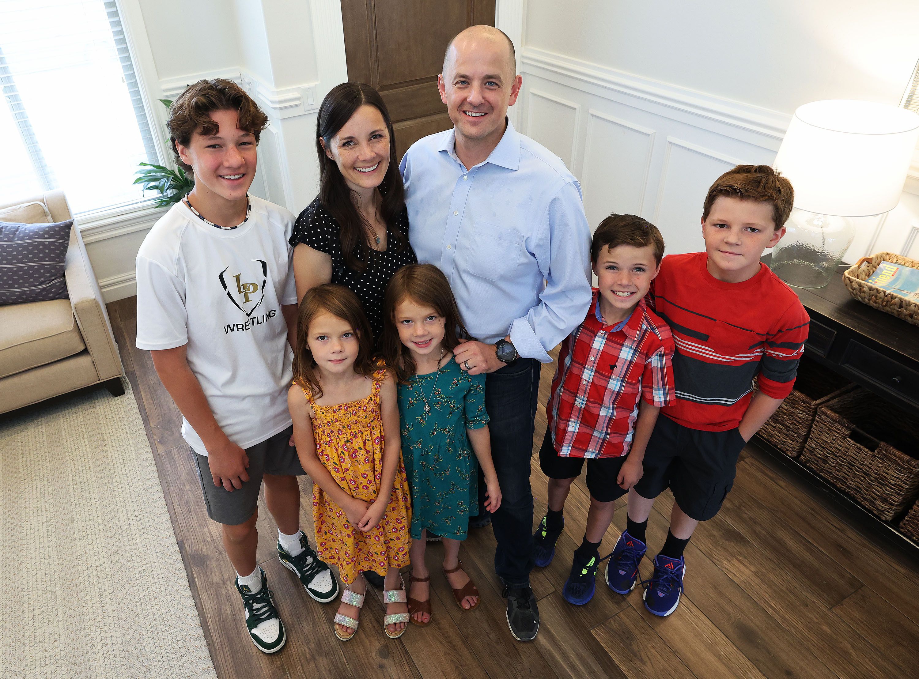 Logan Norton, left, Emily McMullin, Evan McMullin, Brynlee Norton, Maylee Norton, Gavin Norton and Colin Norton pose for a photo at their home in Highland on Aug. 5.