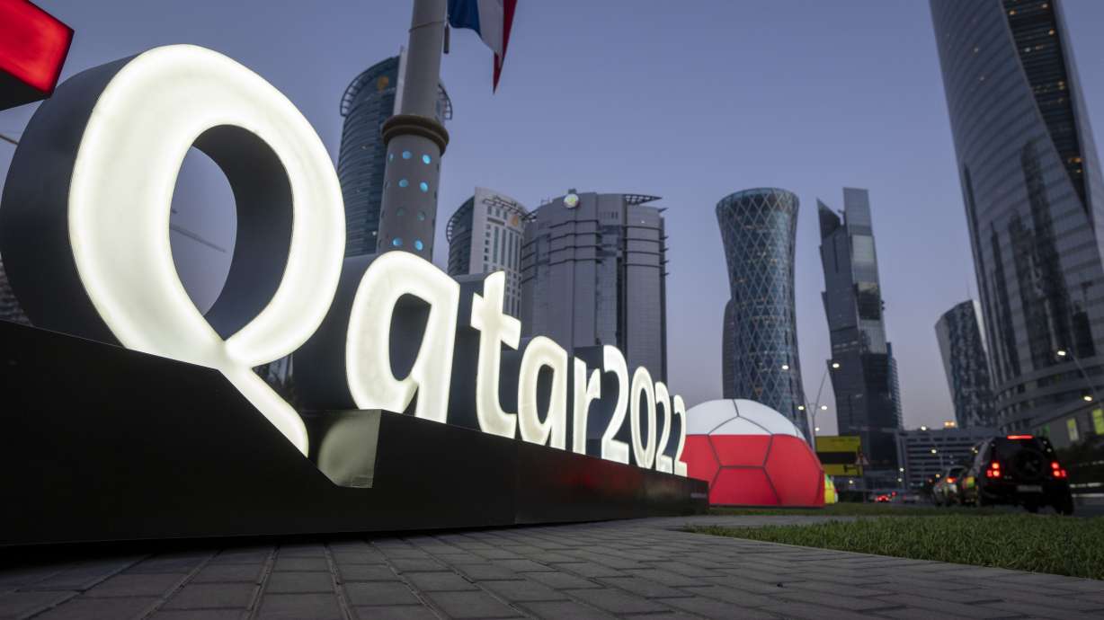 FILE - Branding is displayed near the Doha Exhibition and Convention Center, in Doha, Qatar, March 31, 2022. Qatar recently arrested at least 60 workers who protested going months without pay and deported some of them, an advocacy group said, just three months before Doha hosts the 2022 FIFA World Cup. The move comes as Qatar faces intense international scrutiny over its labor practices ahead of the tournament. The workers' protest on Aug. 14 — and Qatar's reaction to it — could further fuel the concern.