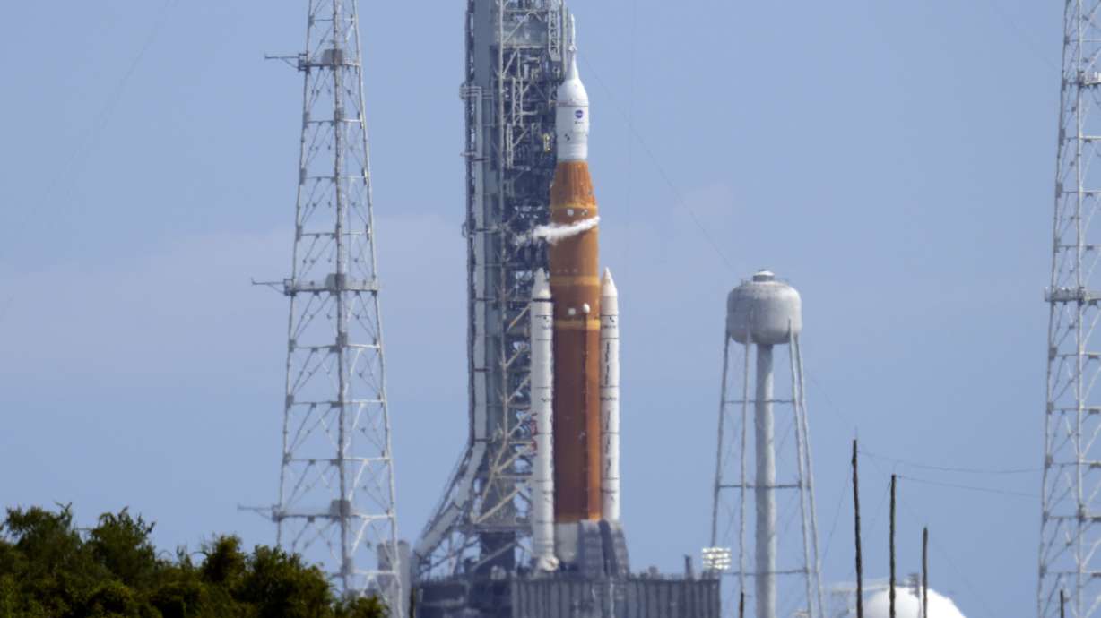 NASA’s new moon rocket sits on Launch Pad 39-B moments after the launch attempt was scrubbed at the Kennedy Space Center Saturday, in Cape Canaveral, Fla.