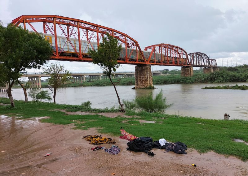 Clothes are seen on the ground of the shore of the Rio Grande river between the U.S. and Mexico after some migrants died and others were rescued as they tried to cross the rain-swollen Rio Grande river into the United States near Eagle Pass, Texas, U.S., in Piedras Negras, Mexico, on Saturday.