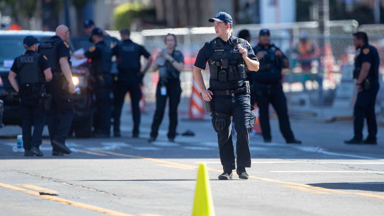 Officers work during an investigation on 100 South, where a shooting left one dead in Salt Lake City on Sept. 3. On Monday, police said they arrested a second suspect and released the identity of a third suspect.