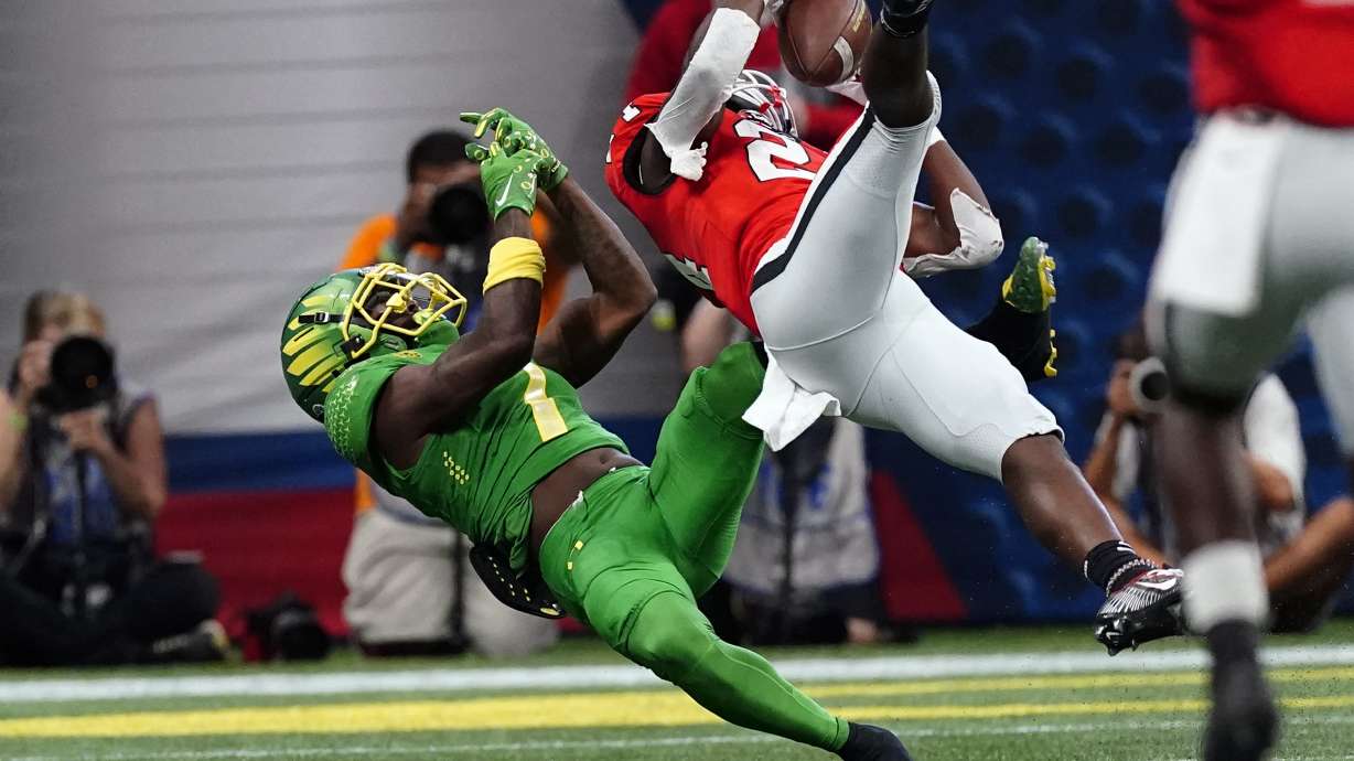 Georgia defensive back Malaki Starks, right, intercepts a pass intended for Oregon wide receiver Seven McGee, left, in the first half of an NCAA college football game Saturday, Sept. 3, 2022, in Atlanta.