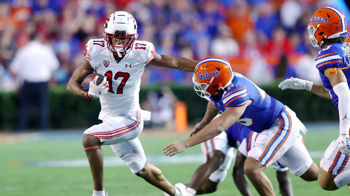 Utah Utes wide receiver Devaughn Vele (17) tries to push Florida Gators long snapper Marco Ortiz (45) as Utah and Florida play in Gainesvillle, Fla., on Saturday, Sept. 3, 2022.