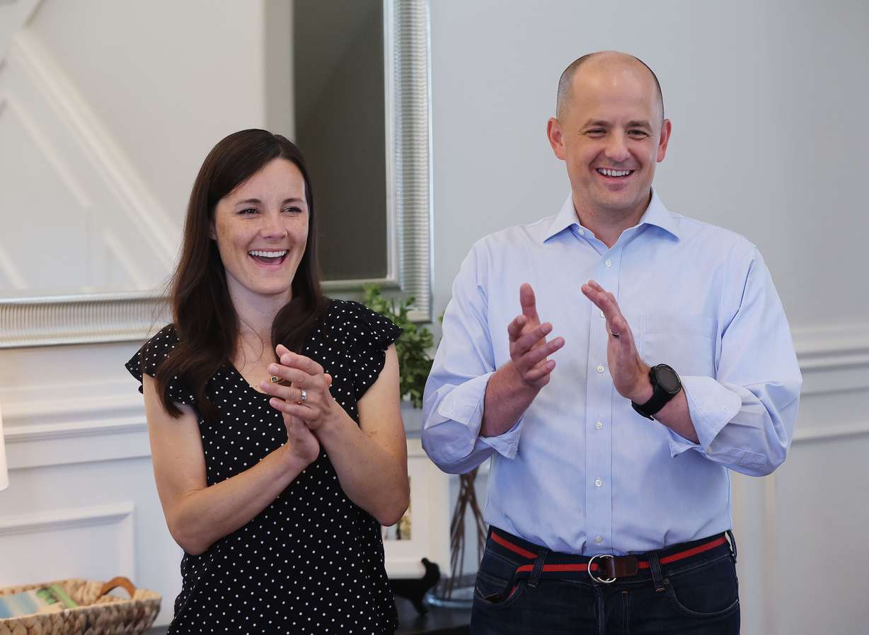 Emily McMullin, left, and her husband, Evan, applaud a piano performance by their children at their home in Highland on Aug. 5. Evan McMullin is running for U.S. Senate.