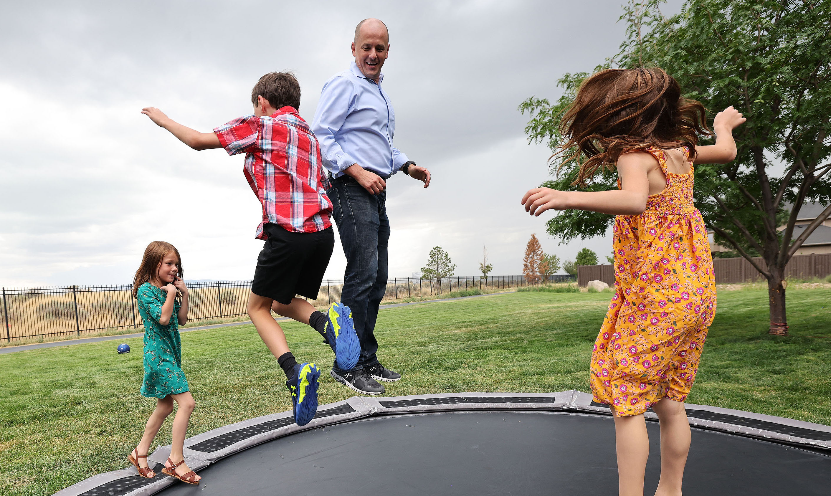 Evan McMullin jumps on a trampoline with his children Maylee, Gavin and Brynlee at their home in Highland on Aug. 5. McMullin is running for for U.S. Senate.