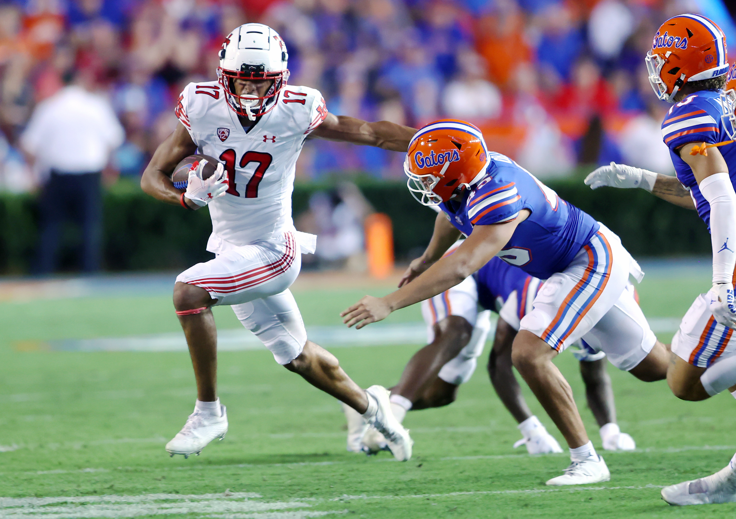 Utah Utes wide receiver Devaughn Vele (17) tries to push Florida Gators long snapper Marco Ortiz (45) as Utah and Florida play in Gainesvillle, Fla., on Saturday, Sept. 3, 2022.