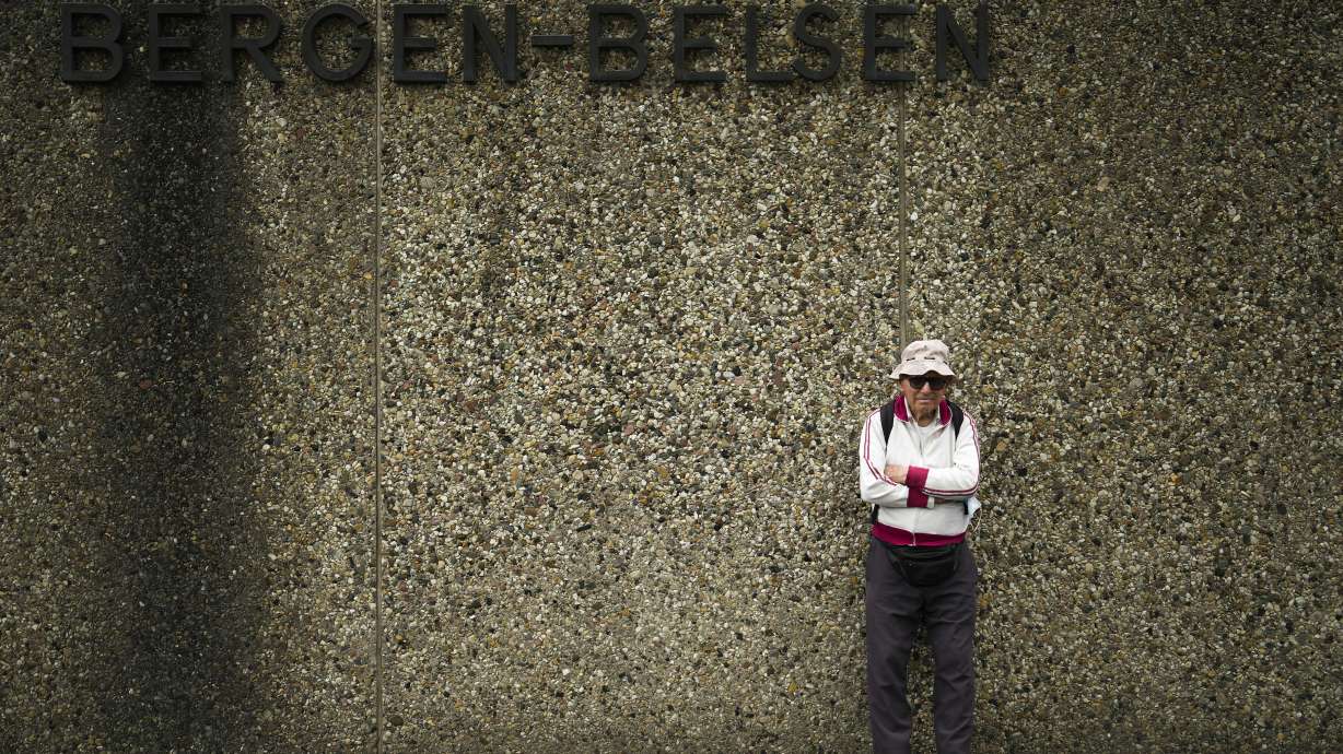 Israeli Olympic race walker Shaul Ladany poses for a photo at the entrance of the Nazi concentration camp Bergen-Belsen in Bergen, Germany, Saturday, Sept. 3, 2022. Shaul Ladany survived a Nazi concentration camp and narrowly escaped the massacre of the Israeli athletes at the 1972 Olympic Games in Munich. Both attempts to murder him happened on German soil in the last century. Many decades later, the 86-year-year old Jew has returned to visit the two places where he narrowly escaped death.