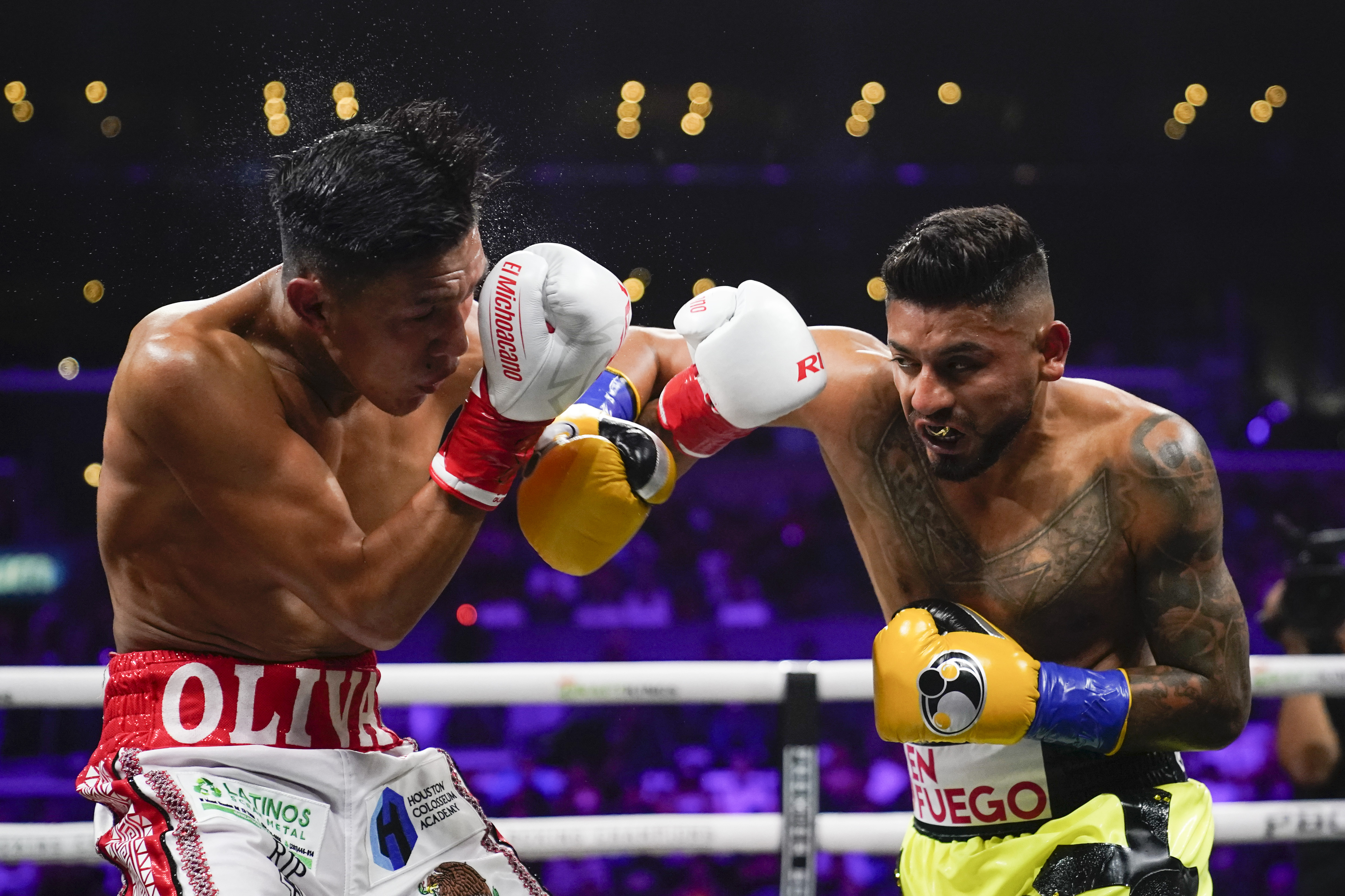 Abner Mares, right, fights Miguel Flores in a lightweights boxing match, Sunday, Sept. 4, 2022, in Los Angeles.