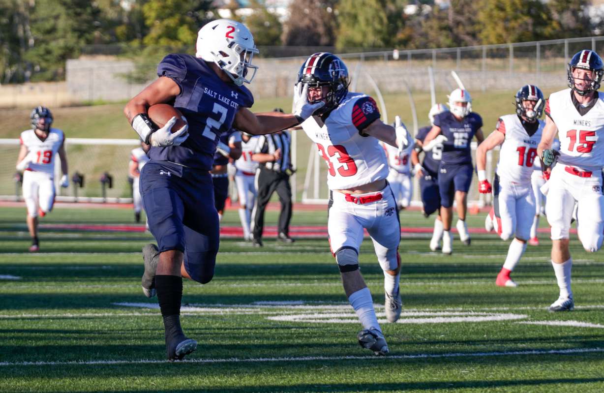 Amini Amone (2) from the East Leopards stiff-arms Carson Baynes from the Park City Miners in Salt Lake City on Friday, Sept. 2, 2022. The Leopards won 21-14.